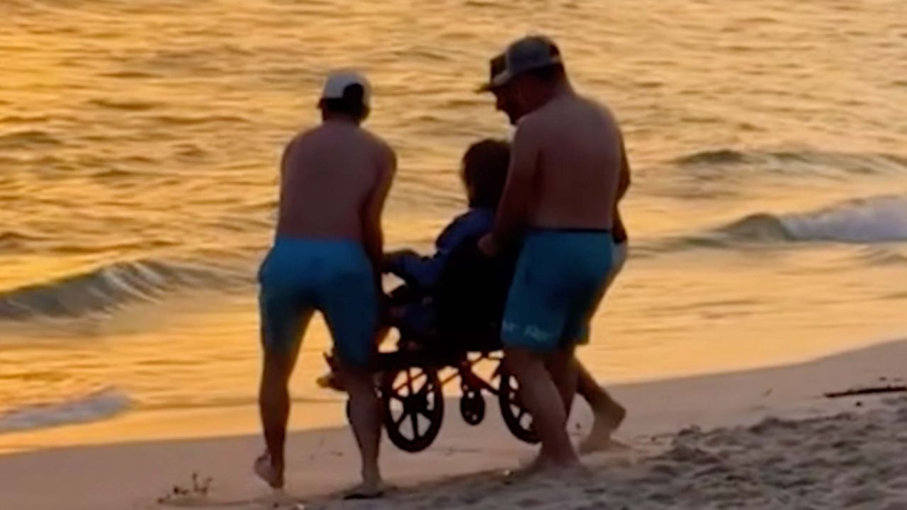 Woman In Wheelchair Carried Into The Ocean To Watch Beautiful Sunset